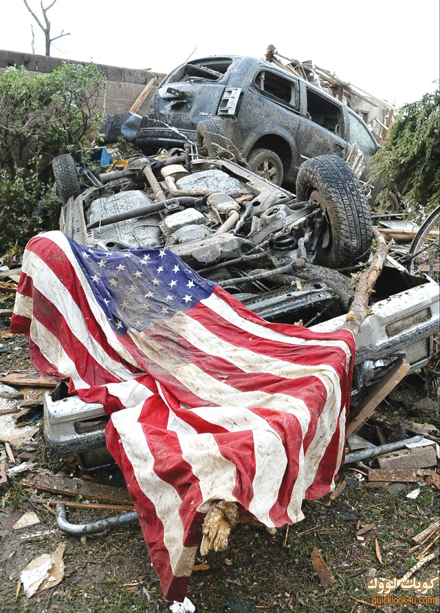 An American flag lies on top of an overturned car after a tornado struck Moore, Oklahoma